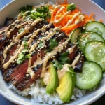 Delve into the vibrant world of Korean cuisine with this delightful recipe for Korean BBQ Steak Rice Bowls with Spicy Cream Sauce. This dish is a wonderful representation of the bold flavors and fresh ingredients that characterize Korean cooking. It combines marinated flank steak, an array of colorful vegetables, and a creamy, spicy sauce that ties everything together beautifully. The result is a harmonious blend of flavors and textures that will excite your palate and satisfy your hunger.